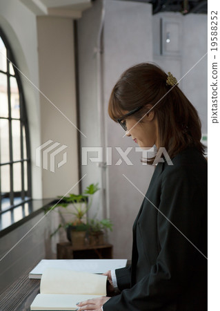 A woman choosing at a book store 19588252
