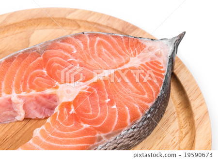 Salmon steak on platter. 19590673