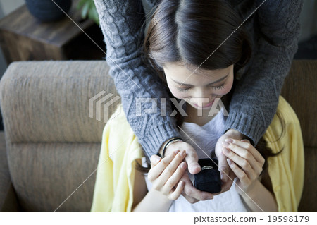 A woman receiving a ring 19598179