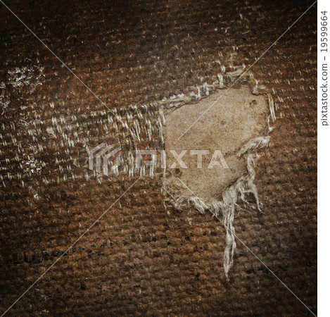 Detail (damage) of an old canvas suitcase 19599664