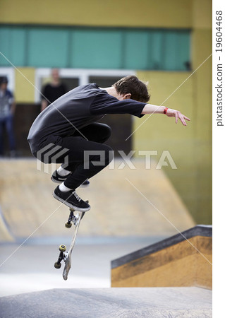 Male skater jumping high in the air 19604468