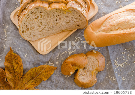 Loaf of sliced bread on wooden background Loaf of sliced bread on wooden background 19605758