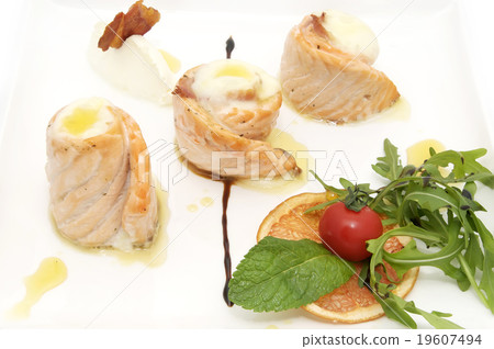fried fish rolls with herbs and vegetables on whit 19607494