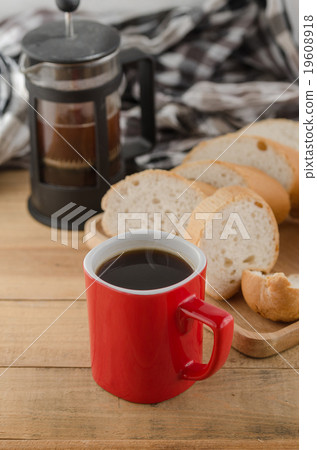Black coffee in a red cup with sliced bread 19608918