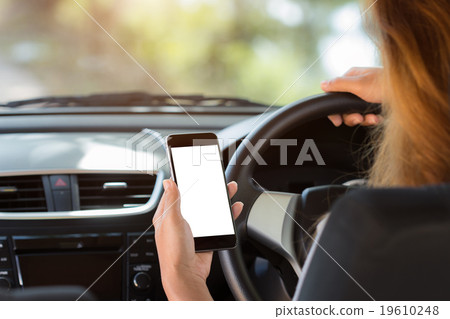 woman holding phone in car white screen 19610248