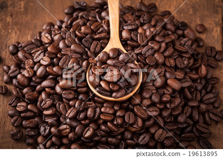 some coffee bean in spoon of coffee bean heap some coffee bean in spoon of coffee bean heap 19613895