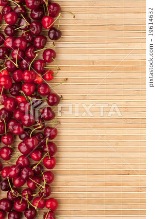 Cherry lying on bamboo mat Cherry lying on bamboo mat 19614632
