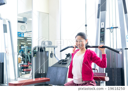 Women exercising at fitness gym Women exercising at fitness gym 19618250