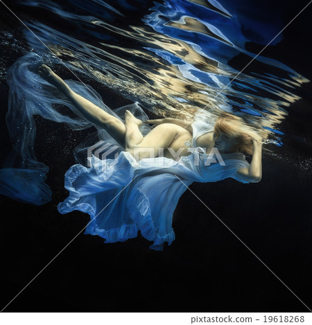 The girl in a beautiful dress under water. The girl in a beautiful dress under water. 19618268