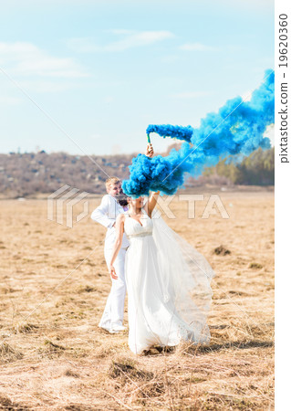 Wedding couple with blue smoke in the park 19620360