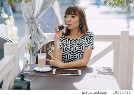 girn in cafe with E-Cigarette girn in cafe with E-Cigarette 19621781