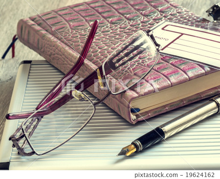 Pen and glasses lying on the notepad Pen and glasses lying on the notepad 19624162