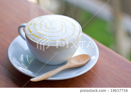 A cup of coffee on wooden table. 19637736