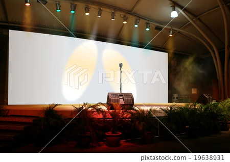 On stage performing live with microphone 19638931