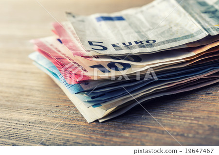 Several hundred euro banknotes stacked by value. 19647467