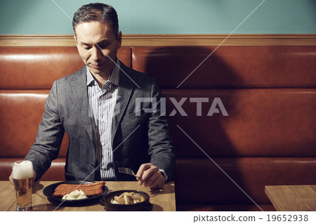 A man dining at a restaurant A man dining at a restaurant 19652938