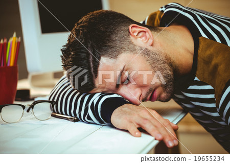 Man asleep at his desk Man asleep at his desk 19655234
