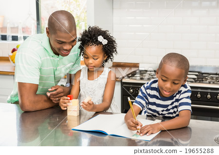 Father with children in the kitchen  19655288