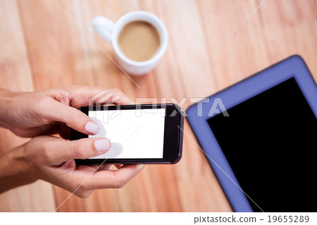 Overhead of feminine hands using smartphone Overhead of feminine hands using smartphone 19655289
