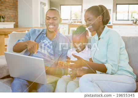 Happy family using laptop on the couch 19655345