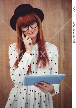 Smiling hipster woman using her tablet 19655513