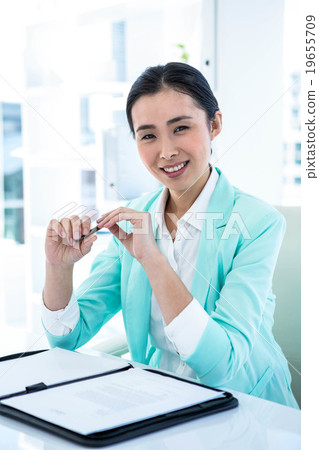 Happy businesswoman sitting down Happy businesswoman sitting down 19655709