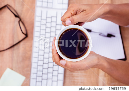 Businesswoman holding black coffee cup 19655769