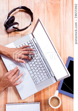 Womans hands typing on a laptop 19655992