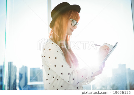 Smiling hipster woman writing notes 19656135