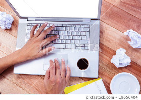 Part of hands typing on laptop 19656404