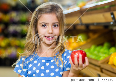 Cute girl holding an apple Cute girl holding an apple 19656459