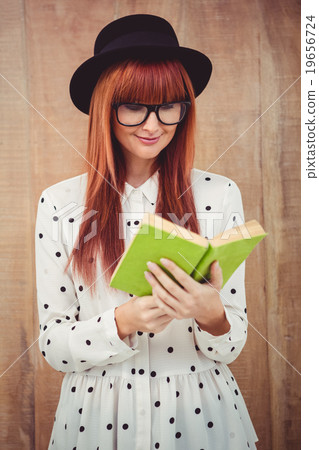 Hipster woman reading a green book 19656724