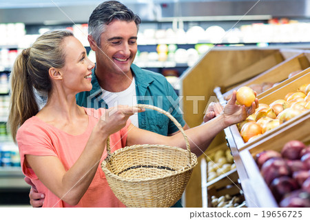 Happy couple holding potatoes Happy couple holding potatoes 19656725