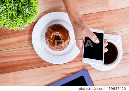 Overhead of feminine hands using smartphone Overhead of feminine hands using smartphone 19657420