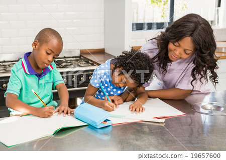 Children doing homework with their mother  19657600