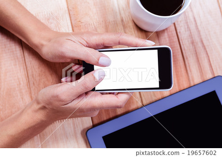 Businesswoman holding smartphone Businesswoman holding smartphone 19657602