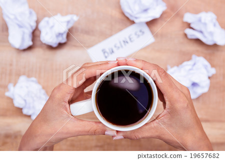 Businesswoman holding black coffee cup 19657682