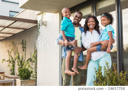 Happy family standing in the garden  19657708