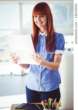 Smiling hipster woman holding document  19658040