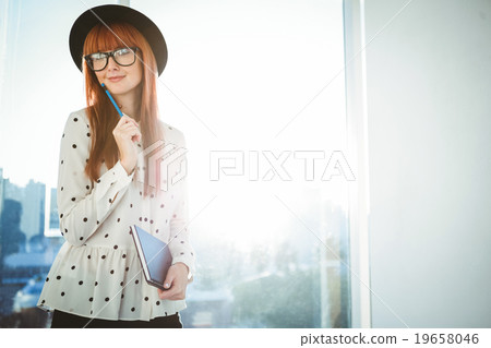 Smiling hipster woman writing notes Smiling hipster woman writing notes 19658046