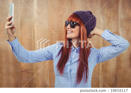 Smiling hipster woman taking selfie 19658117