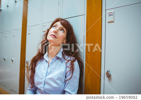 Mature student feeling stressed in hallway 19659082