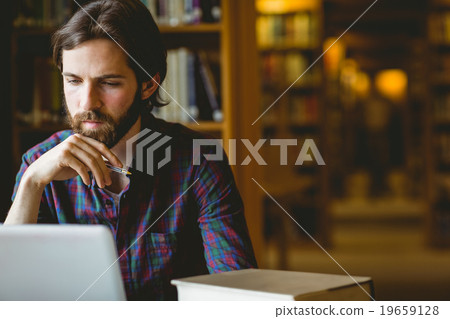 Stock Photo: Hipster student studying in library