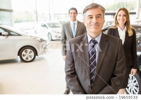 Group of smiling business team standing together Group of smiling business team standing together 19659538