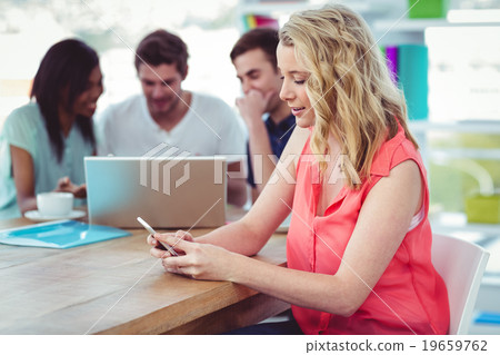 Smiling creative businesswoman working with co-workers Smiling creative businesswoman working with co-workers 19659762