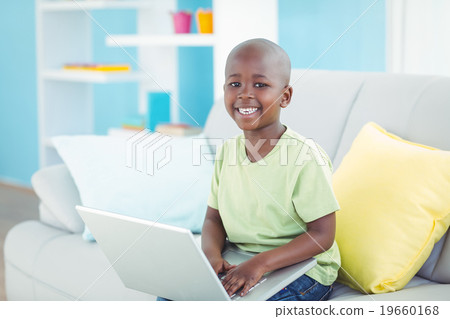 Happy boy using a laptop Happy boy using a laptop 19660168