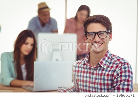 Young creative worker smiling at camera Young creative worker smiling at camera 19660171