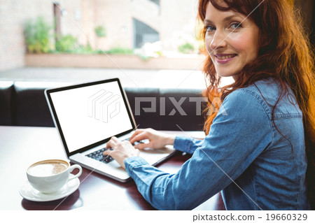 Mature student using laptop in cafe 19660329