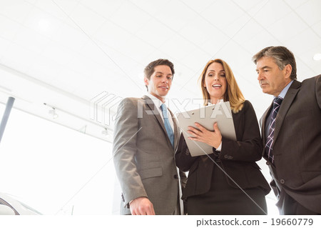 Group of smiling business team standing together Group of smiling business team standing together 19660779