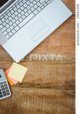 Business desk with laptop and calculator 19661006